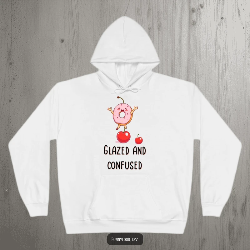 Funny Donut Hoodie depicting a cheerful donut person performing a balancing act on a cherry with pure delight.